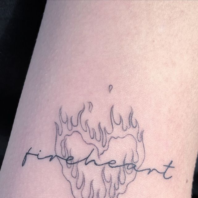 a tattoo with the word fire and flames on it