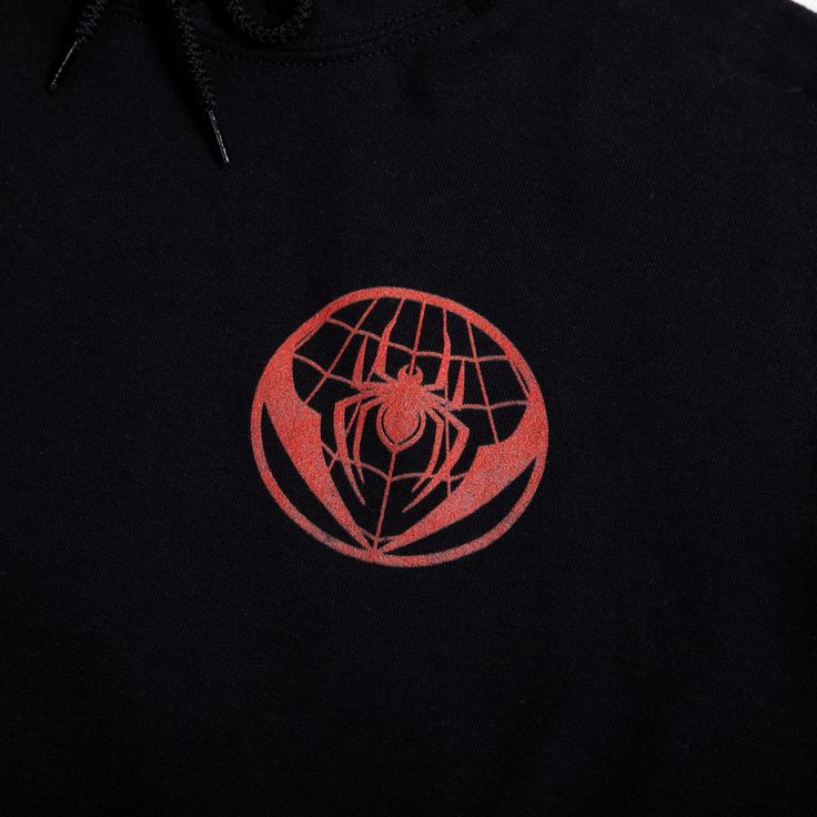 a black hoodie with a red spider logo on it