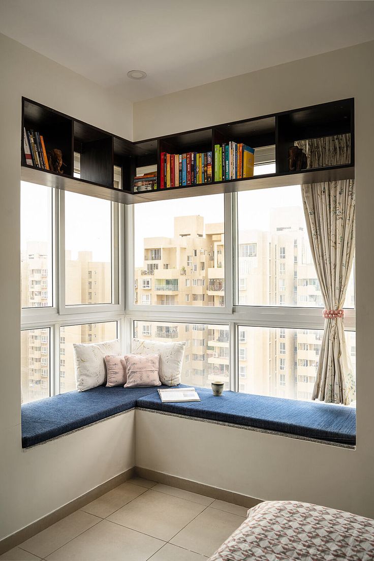 a window seat with bookshelves on the windowsill