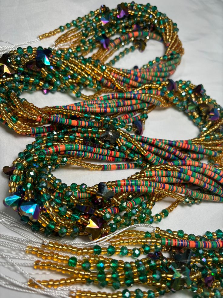 Handmade beaded jewelry made from recycled materials, materials sourced from Nigerian and China. Bohemian Faceted Beads For Festival, Colorful Heishi Beads For Festival, Bohemian Czech Glass Faceted Beads, Artisan Green Beaded Bracelets For Beach, Handmade Heishi Beads For Festival, Multi-strand Beaded Bracelets With Large Beads For Festivals, Unique Handmade Multi-strand Beads, Eclectic Green Round Bead Jewelry, Artsy Beaded Jewelry For Festivals