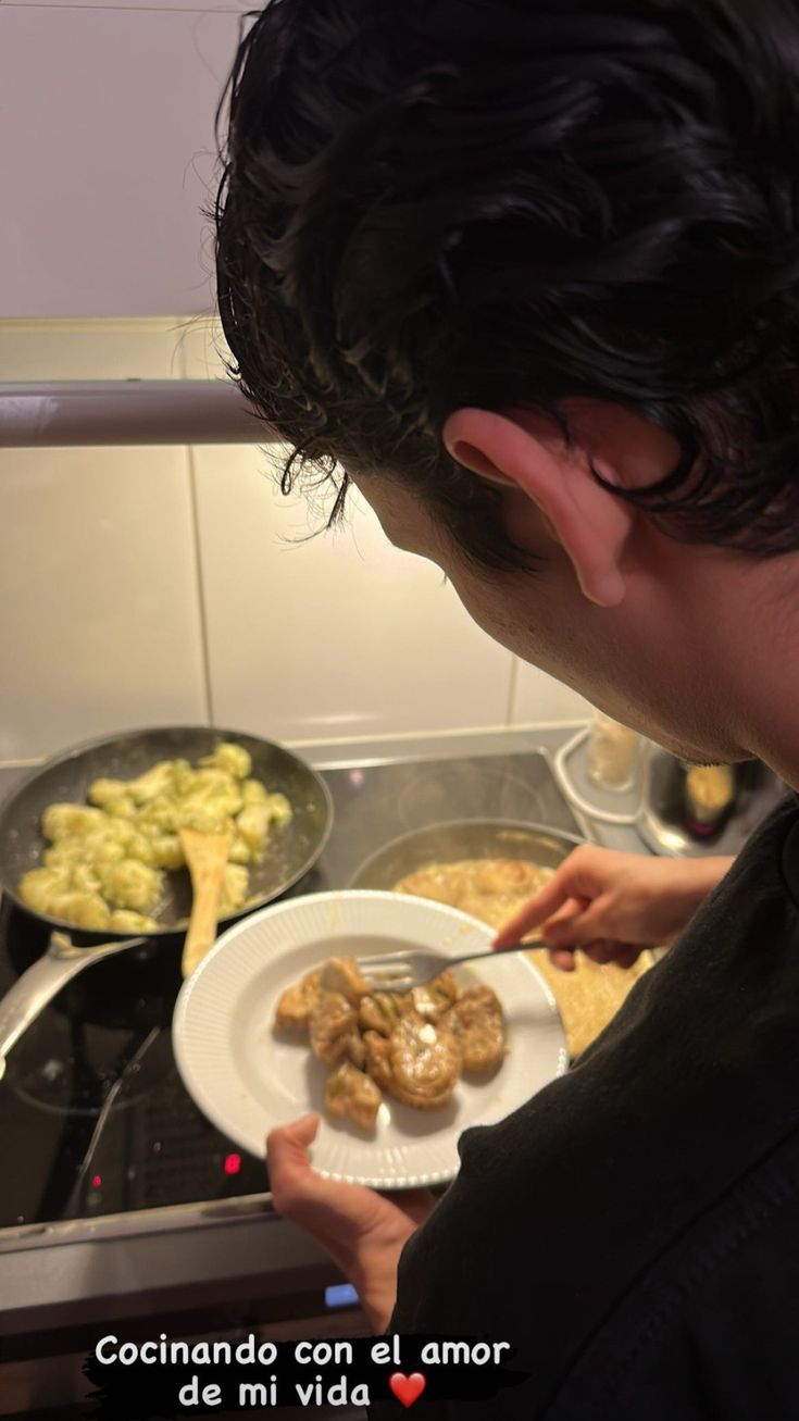 a man is holding a plate with food on it