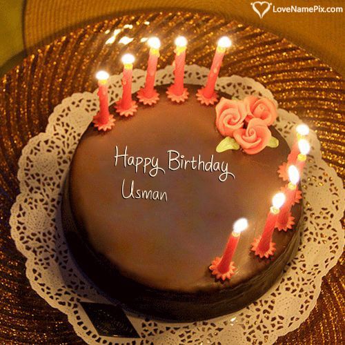 a chocolate birthday cake with lit candles on a lace doily, and the words happy birthday you name here written on it