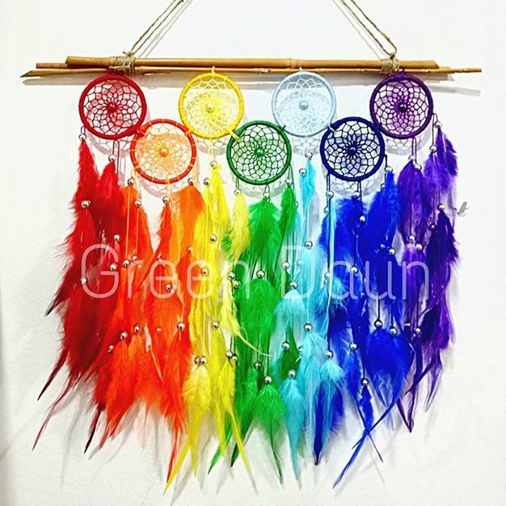 a rainbow dream catcher hanging on a wall