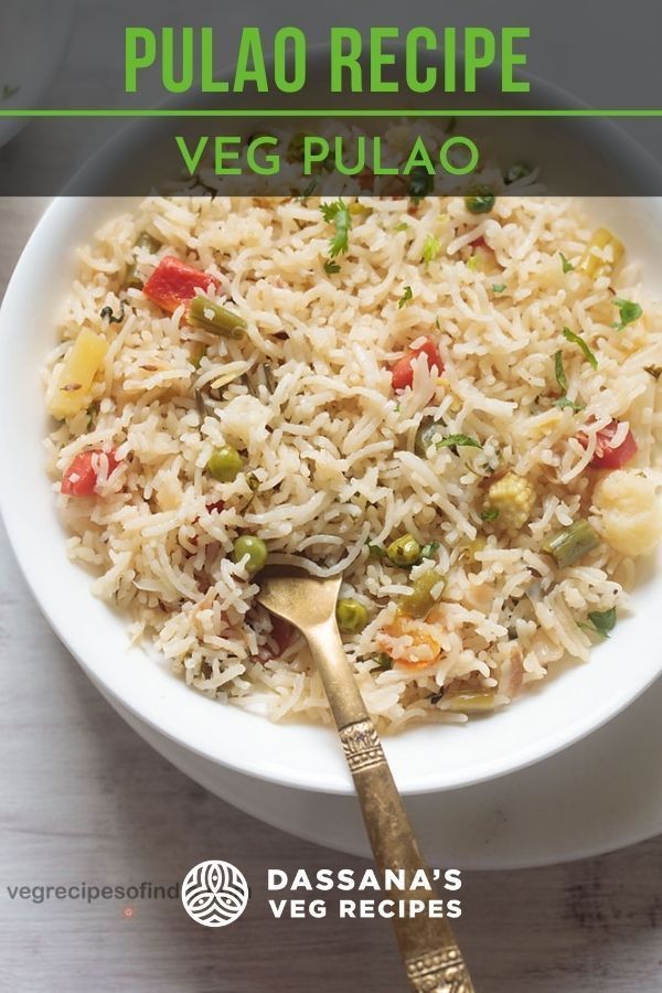 a white bowl filled with rice and veggies next to a spoon on top of a table