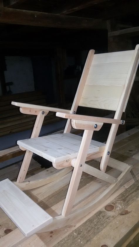 a wooden rocking chair sitting on top of a hard wood floor