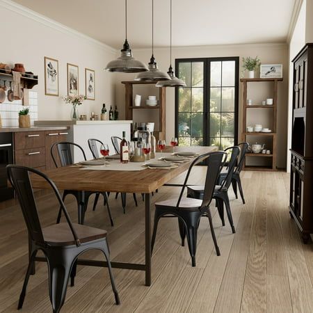 a dining room table and chairs in front of an open kitchen with sliding glass doors