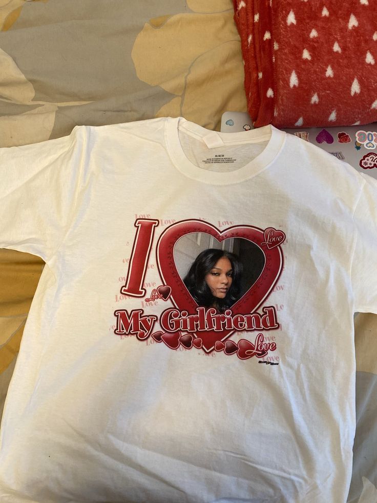 i love my girlfriend t - shirt laying on the bed