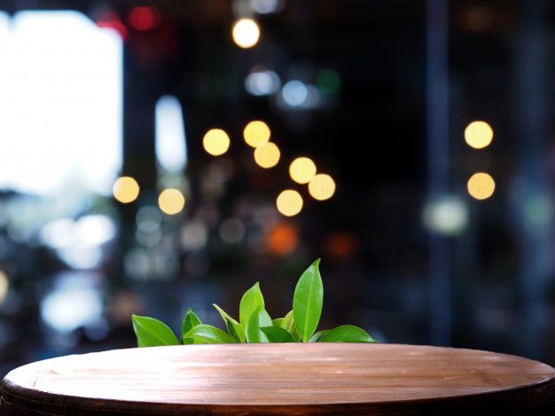 a wooden table topped with a plant on top of it