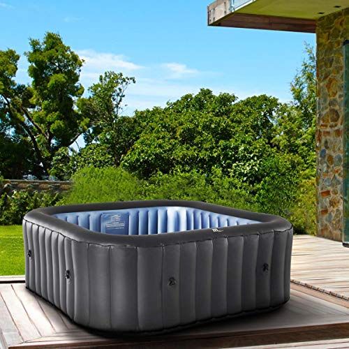 an inflatable hot tub sitting on top of a wooden deck