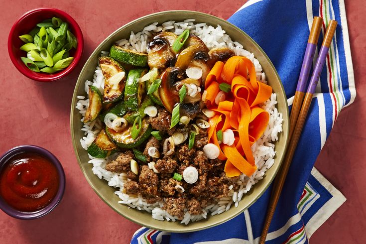 a bowl filled with rice, meat and vegetables