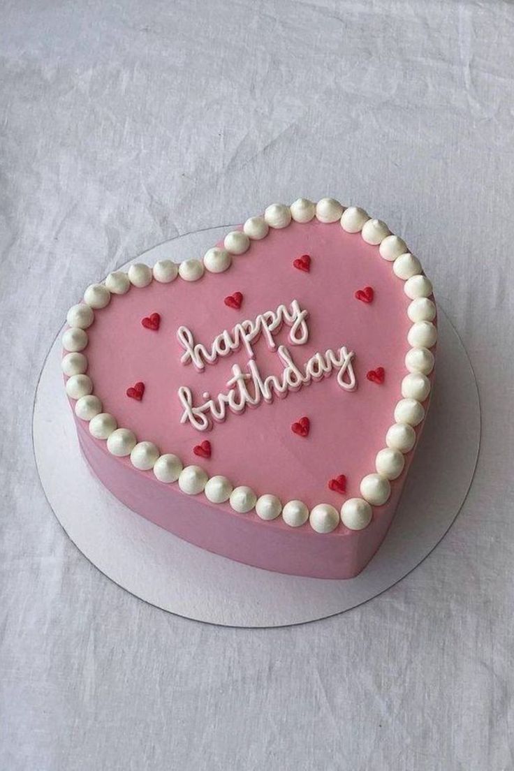 a heart shaped birthday cake with the words happy birthday written on it