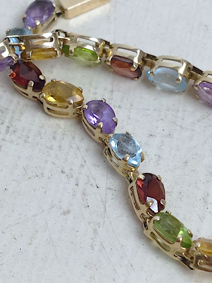 Yellow Gold Multi-stone Oval Bracelets, Yellow Gold Multi-stone Oval Bracelet, Yellow Gold Oval Bracelet With Multi-stone, Yellow Gold Oval Multi-stone Bracelet, Elegant Rainbow Round Bracelets, Yellow Gold Gemstone Bracelets For Party, Yellow Gold Gemstone Bracelet For Party, Elegant Rainbow Bracelets For Parties, Multicolor Gold Bracelet With Gemstones