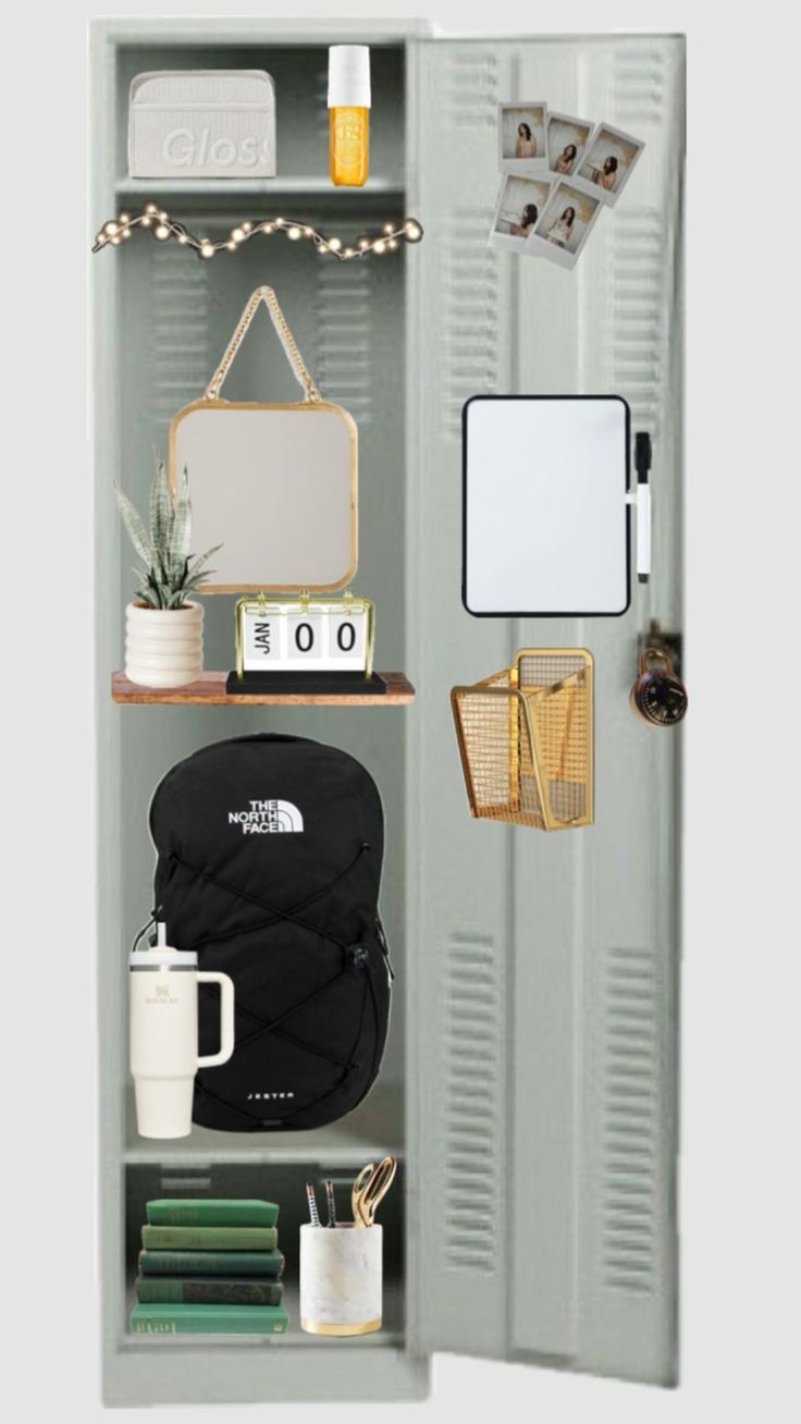 an open locker with various items on the shelves and in front of it is a mug, mirror, camera, books, notebooks