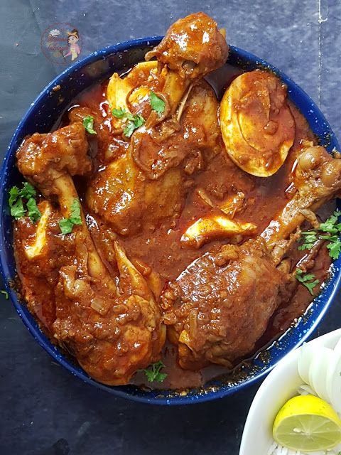 a blue bowl filled with meat covered in sauce