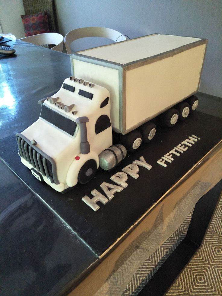 a birthday cake shaped like a truck on top of a table