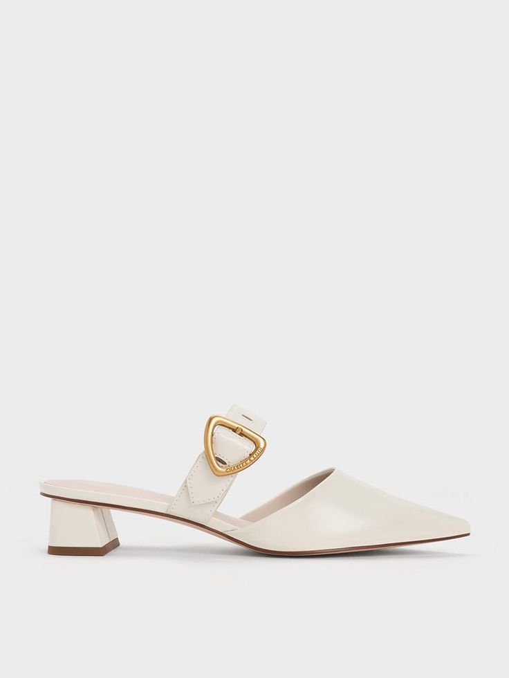 Elevate your style with the timeless elegance of the Sepphe mules. From their polished cream-white hue to their sleek pointed-toe silhouette, these mules exude class and sophistication from every angle. Designed to be versatile and adaptable, they are the perfect companion for any occasion. Whether you're heading out for a casual day with friends or stepping into the office, the Sepphe will effortlessly elevate your outfit. Pair them with tailored shorts for a chic and relaxed look, or dress them up with jeans for a polished appearance. White Mules Heels, Bridal Shoes Low Heel, White Mules, Cream Heels, Day With Friends, Elevated Casual, Ecru Color, Faux Leather Heels, Tailored Shorts