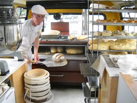 a man is working in a bakery making bread