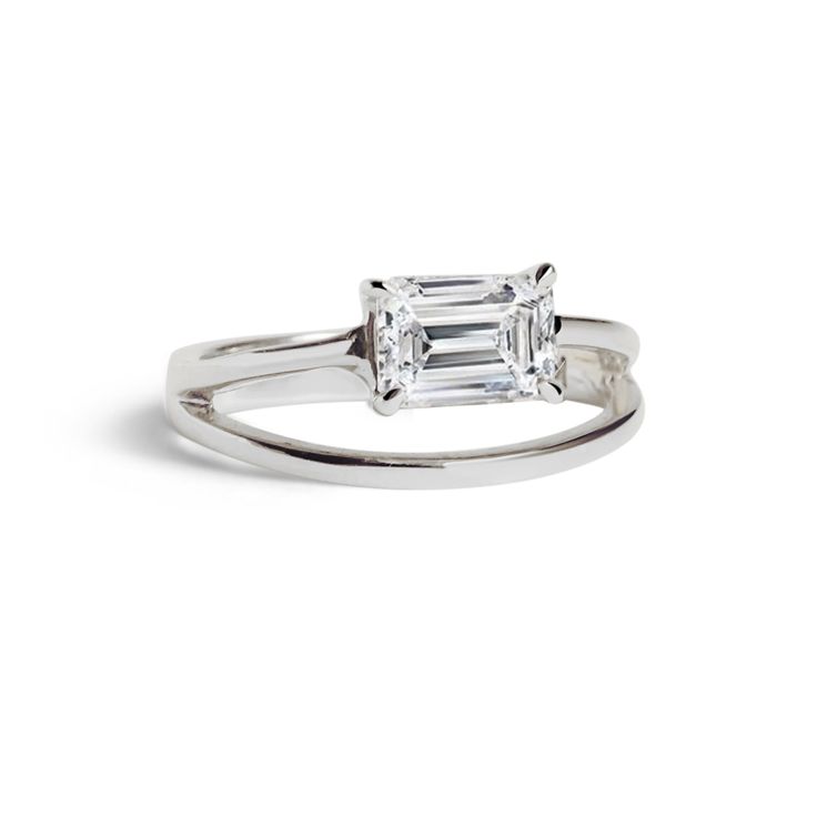 a white gold ring with an emerald cut diamond