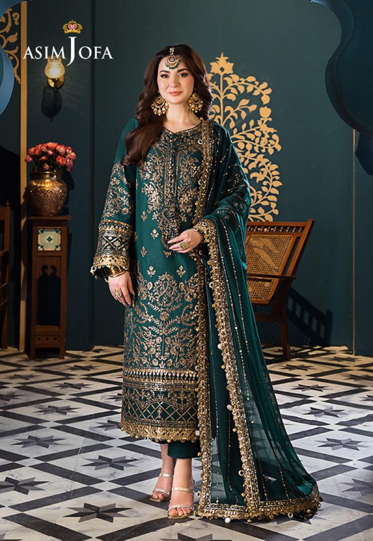 Shirt: Lawn By Pcs: 3 Pcs Trouser: Cambric Dupatta: Chiffon Color: Green Product Details Embark on a journey of elegance with our golden threads of teal dreams ensemble. Like shimmering threads weaving through a tapestry of dreams, antique gold zari and delicate 3mm sequins adorn the rich teal fabric creating an enchanting aura. The embroidered panels and back whisper tales of timeless romance while the borders for the daman, sleeves, and chaak add a touch of magic. With a stunning embroidered d Asim Jofa, Embroidered Suit, Pakistani Designer Suits, Pakistani Lawn Suits, Shirt Colour, Lawn Dress, Chiffon Collection, Embroidered Sleeves, Lawn Suits