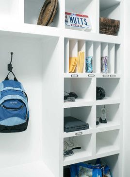 a white book shelf with a blue backpack hanging on it