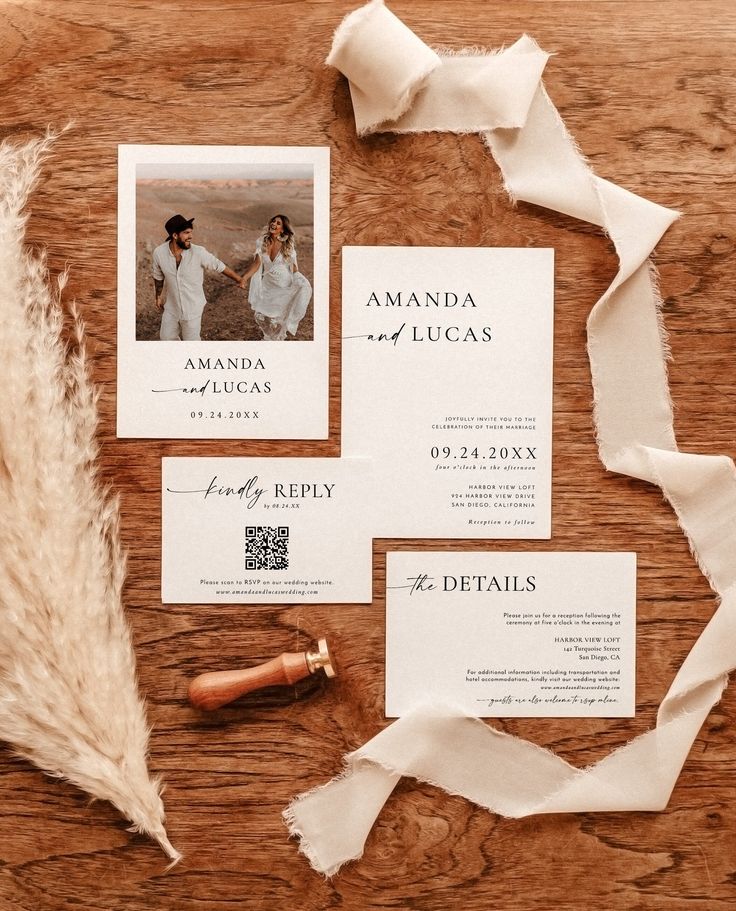 the wedding stationery is laid out on a wooden table