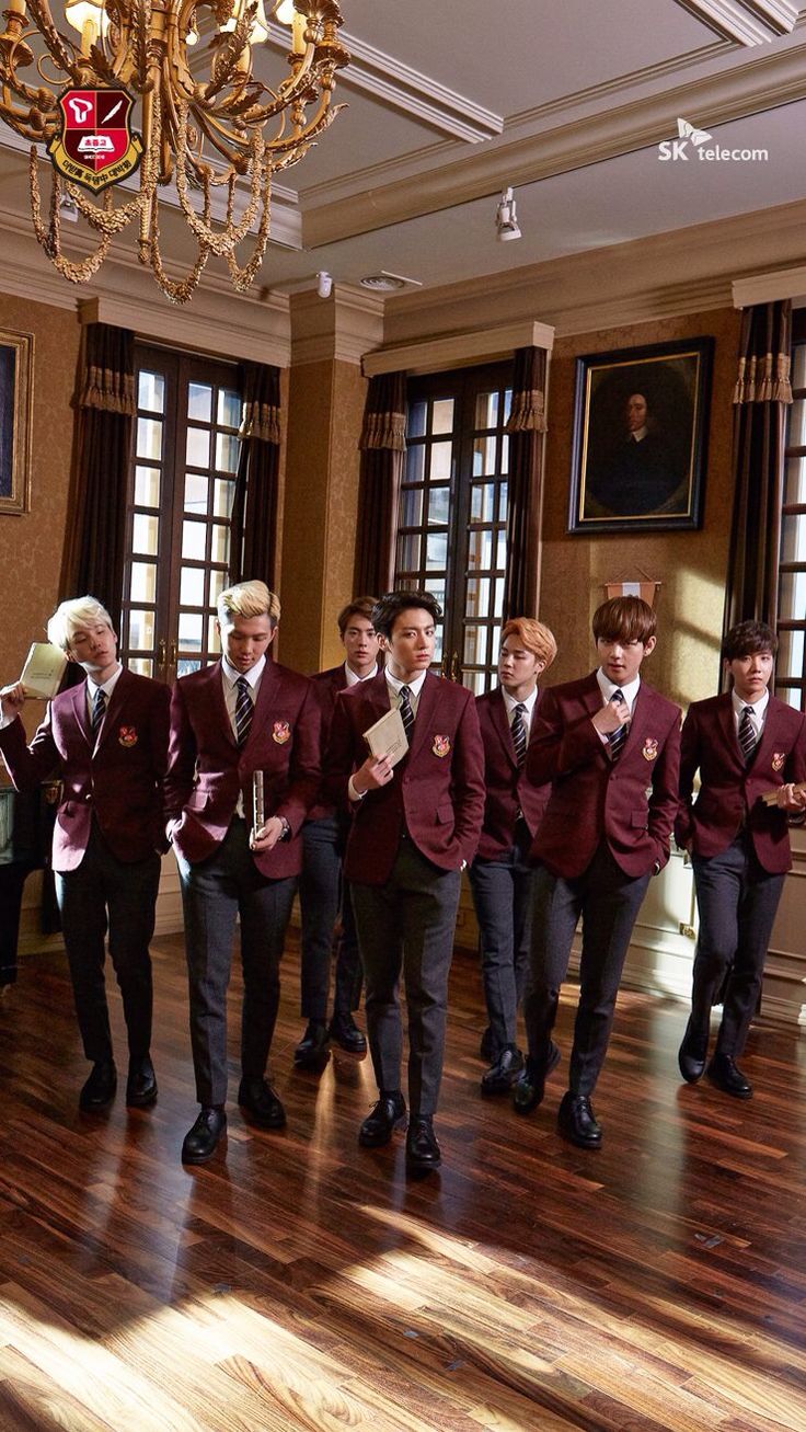 a group of young men standing next to each other on top of a hard wood floor