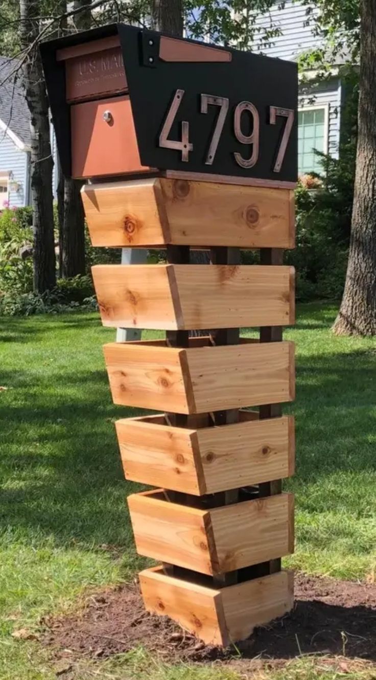 a mailbox that is made out of wood and has the number 4797 on it