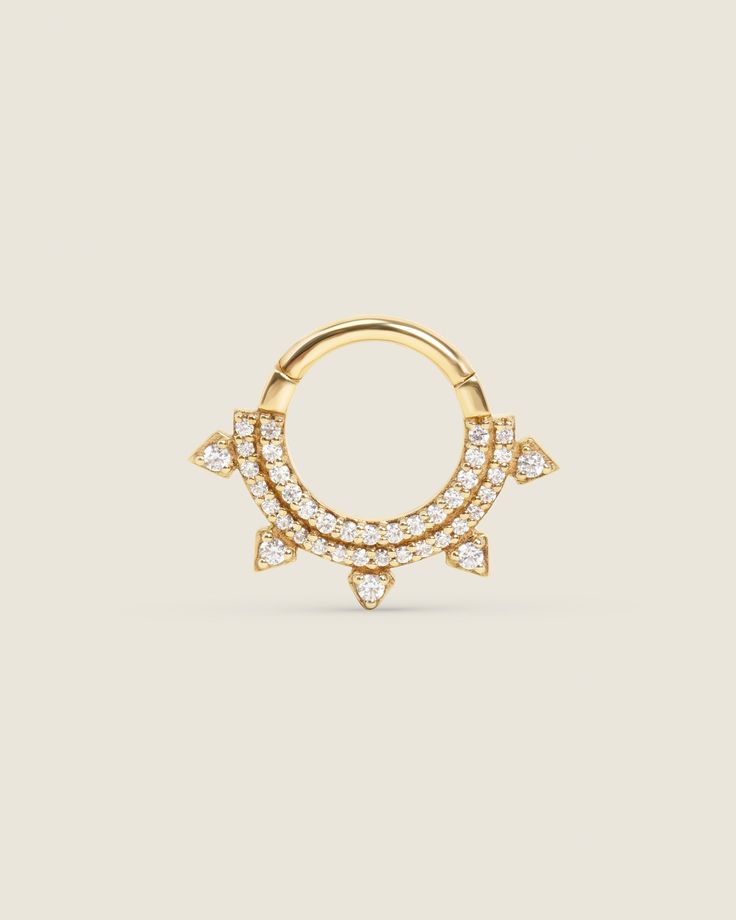 a gold nose ring with small diamonds