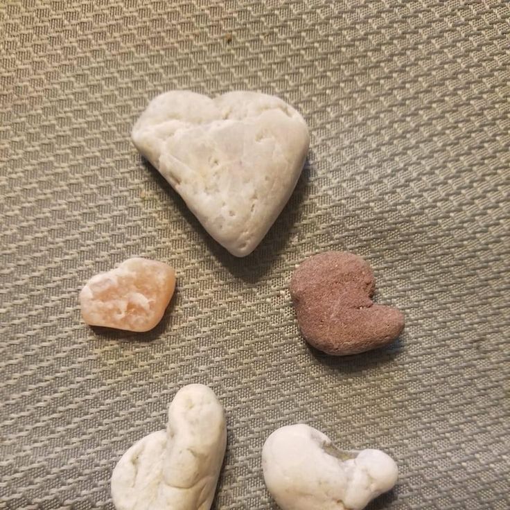 four different types of rocks sitting on top of a table next to eachother