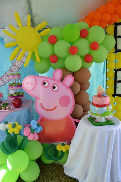 a peppa pig birthday party with balloons and decorations