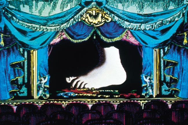 an animated image of a person laying down on a stage with blue drapes and curtains