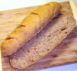 a loaf of bread sitting on top of a wooden cutting board