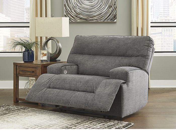 a living room with a gray reclining chair