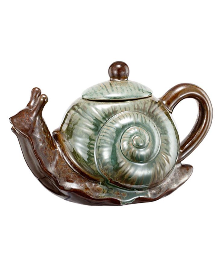 a ceramic teapot with a snail on it