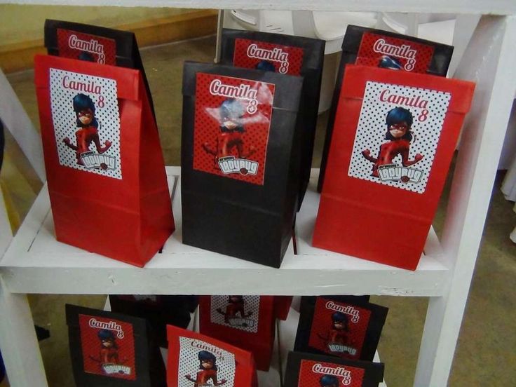 several small bags with pictures on them are sitting on a shelf in front of other packages