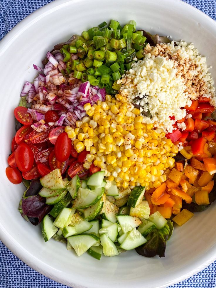 a white bowl filled with different types of vegetables