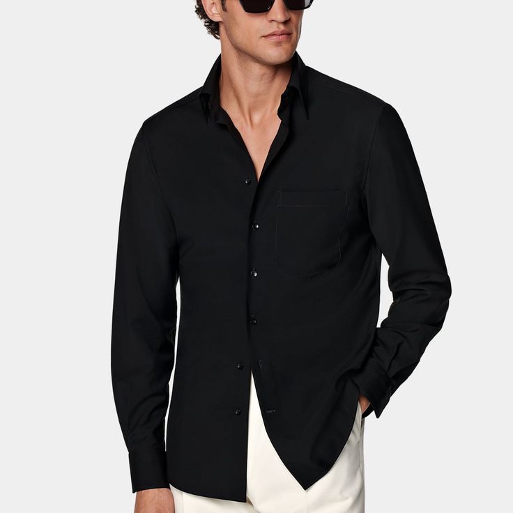 This black shirt is tailored to a casual tailored fit and features a large point collar, French placket, and single cuffs. Black Cotton Shirt With Concealed Placket, Classic Black Tops With Welt Pockets, Classic Black Shirt With Welt Pockets, Black Collared Shirt With Concealed Placket, Classic Black Button-up Shirt, Black Shirt With Welt Pockets For Work, Classic Black Single Breasted Top, Black Collared Top With Welt Pockets, Classic Black Single-breasted Top