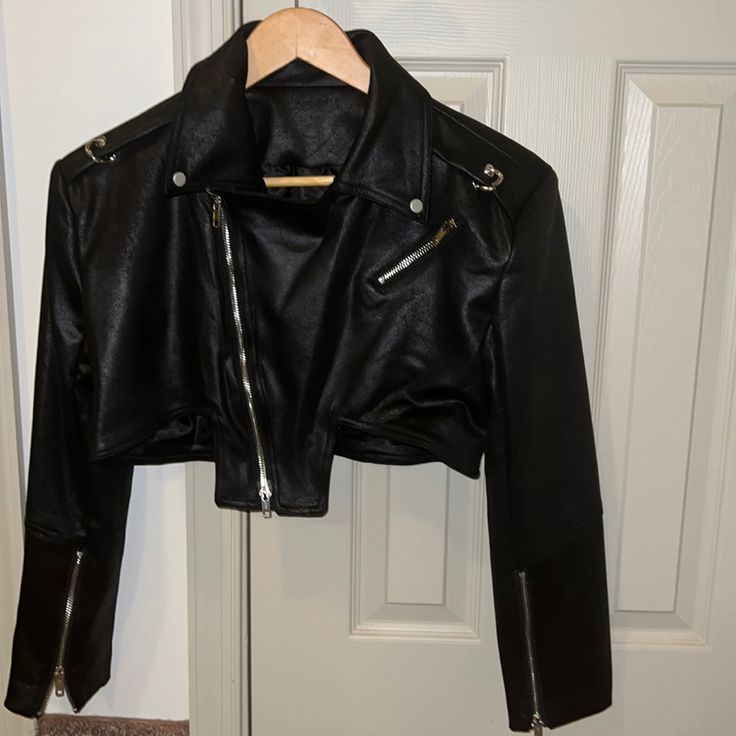 Faux Leather Crop Moto Jacket With Silver Zipper & Details. Never Worn. (Tags Did Not Come On Item) Black Cropped Leather Biker Jacket, Edgy Cropped Jacket With Zipper For Night Out, Leather Biker Jacket For Parties, Black Leather Cropped Jacket For Night Out, Leather Biker Outerwear For Party, Black Fitted Faux Leather Cropped Jacket, Trendy Cropped Biker Jacket For Night Out, Fitted Black Faux Leather Cropped Jacket, Black Leather Cropped Jacket With Zipper