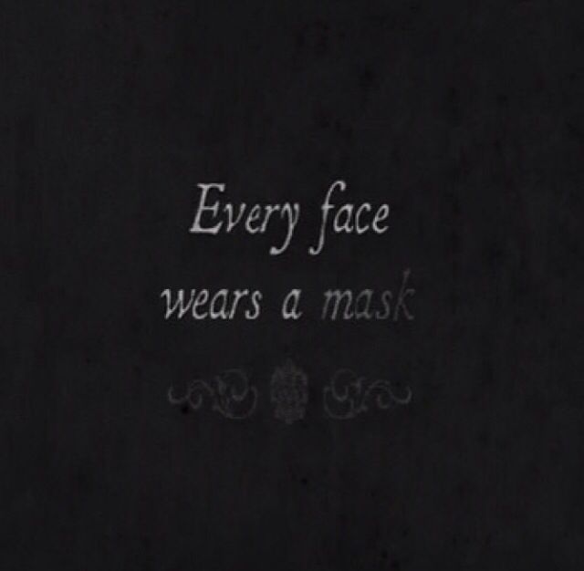 the words every face wears a mask are written in white chalk on a black background