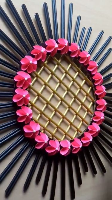 a mirror made out of sticks with flowers on it