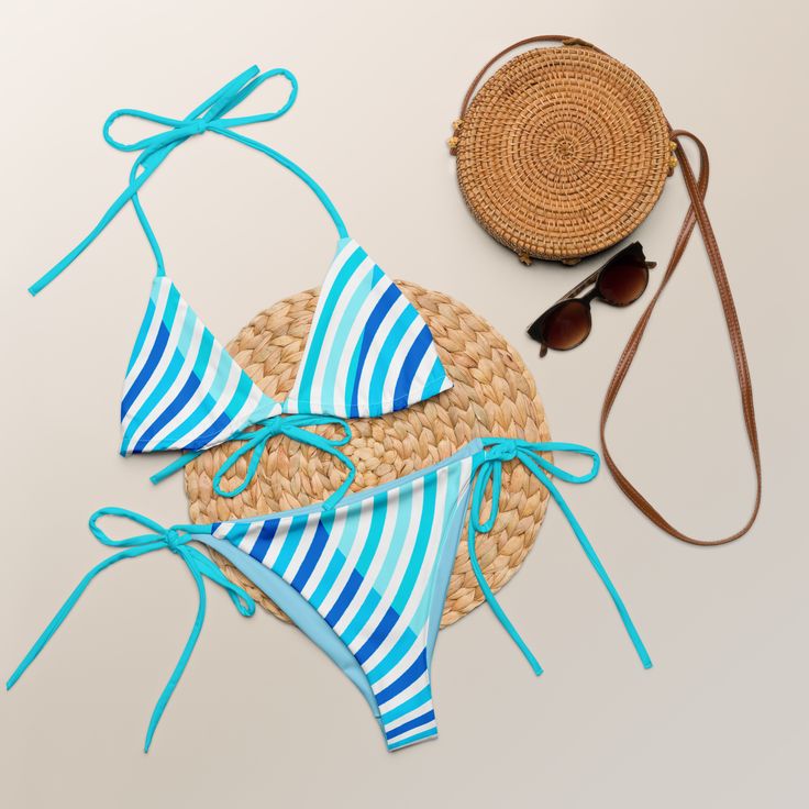 Stay comfortable and beach ready all summer in this FYC String Bikini set. It’s made from soft recycled polyester with double-layering and UPF 50+. Style the straps how you like, and get ready to swim! 🏊‍♀️ 🌟 Features: Soft and stretchy material with UPF 50+ protection. Available in sizes up to 4XL. Bikini top comes with removable padding for comfort. Multiple ways to tie and style the bikini set. 🌊 Disclaimer: To make your All-Over Print Recycled String Bikini last longer, thoroughly rinse i Beach Season Swimwear With Adjustable Straps And Tie-side Bottom, Adjustable Straps Tie-side Bottom Swimwear For Beach Season, Adjustable Swimwear For Pool Vacation, Beach Swimwear With Adjustable Straps And Tie-side Bottom, Adjustable Beachy Swimwear For Beach Season, Strappy Swimwear For Sunbathing, Adjustable Summer Tankini For Swimming, Strappy Swimwear For Sunbathing And Beach Season, Blue Swimwear For Summer Beach Season