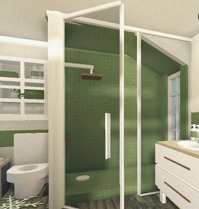 a bathroom with green walls and wooden flooring is shown in this image, there is a shower stall next to the toilet