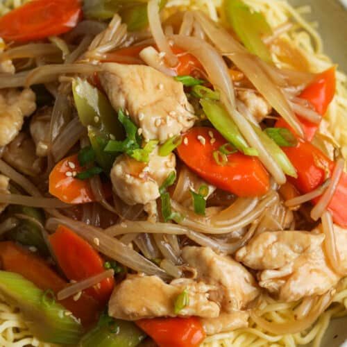 chicken and vegetable stir fry in a white bowl