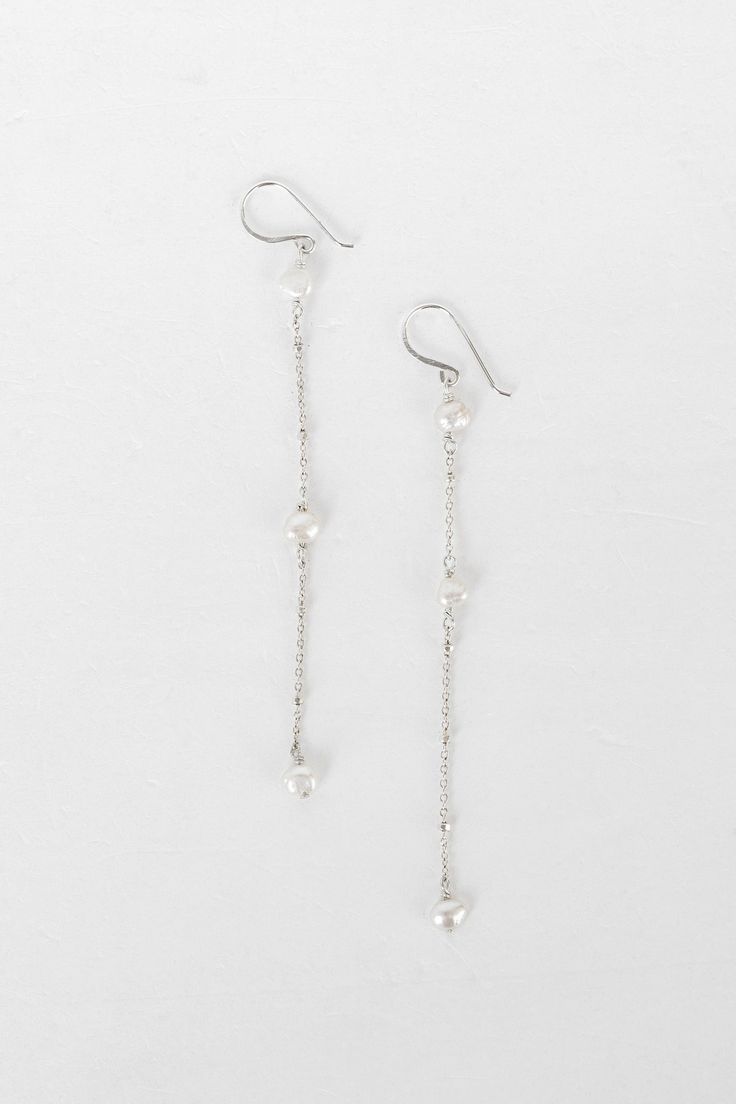 Inspired by the dreamy feeling of looking up into the clouds, the Cloud Collection reimagines historical jewelry elements resulting in timeless, airy, and whimsical jewelry that will have you floating on cloud nine. A freshwater pearl is not mined and shaped. It is born complete and lovely, beneath the water. Baroque pearls are especially "wabi sabi," beautiful in their asymmetry and each one of a kind. ﻿- 6mm freshwater pearls﻿- 18k Vermeil ﻿- About 3 1/2" long Timeless White Linear Earrings For Wedding, White Gold Sterling Silver Earrings With Pearl Chain, Silver Drop Earrings With Akoya Pearl, Sterling Silver Drop Jewelry With Pearl Charm, Delicate Sterling Silver Long Drop Linear Earrings, Silver Akoya Pearl Chain Earrings, Delicate Akoya Pearl Earrings, Pearl White Sterling Silver Pearl Earrings With Chain, Sterling Silver Linear Pearl Drop Earrings