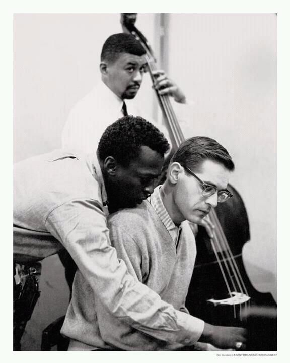 two men are playing the piano together