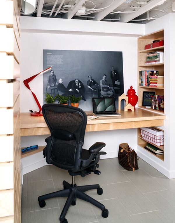 an office area with a desk, chair and book shelf in the corner is shown