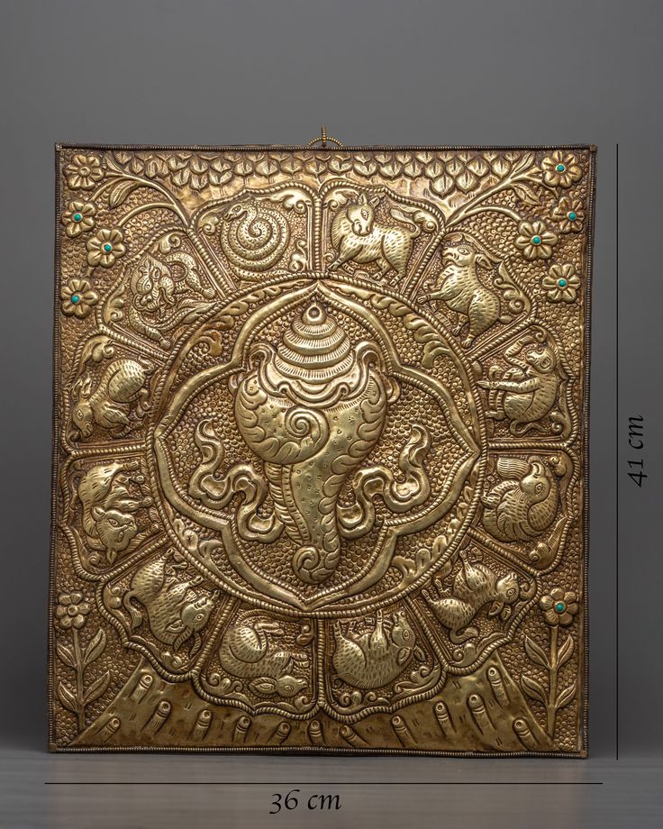 Sankha Metal Wall Hanging About Our Product: A stunning combination of artisanal craftsmanship and spiritual meaning, we present our Sankha Metal Wall Hanging Thanka with Zodiac Sign. An elegant blend of artistic beauty and tradition is achieved in this magnificent artwork, which has the venerated Sankha at its center, surrounded by finely wrought Zodiac signs.The Thanka is an authentic and elegant piece of art, with each detail created with care on a brass body. The piece has a classic appeal t Buddhist Iconography, Indian Artwork, Shibori Fabric, Dark Creatures, Thangka Painting, Metal Wall Hangings, Brass Material, Metal Walls, Zodiac Signs