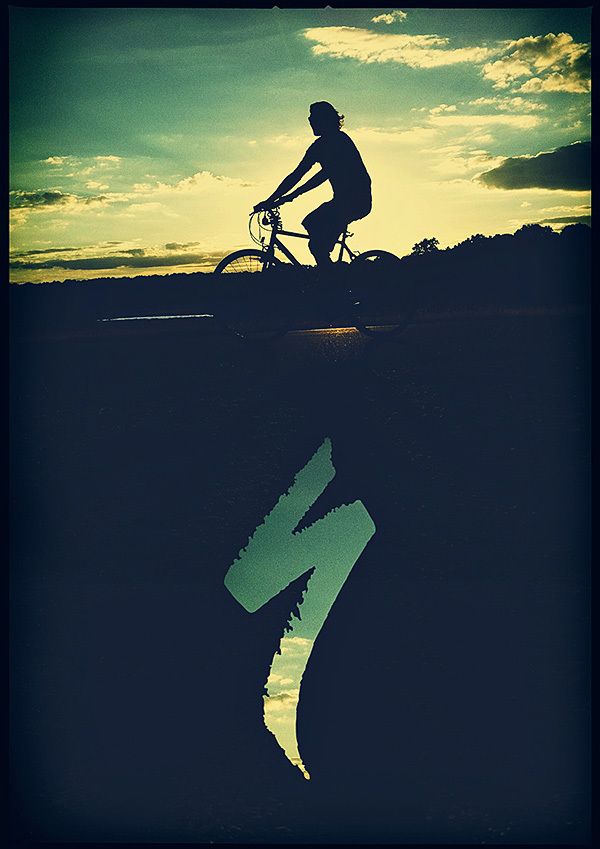 the silhouette of a person riding a bike