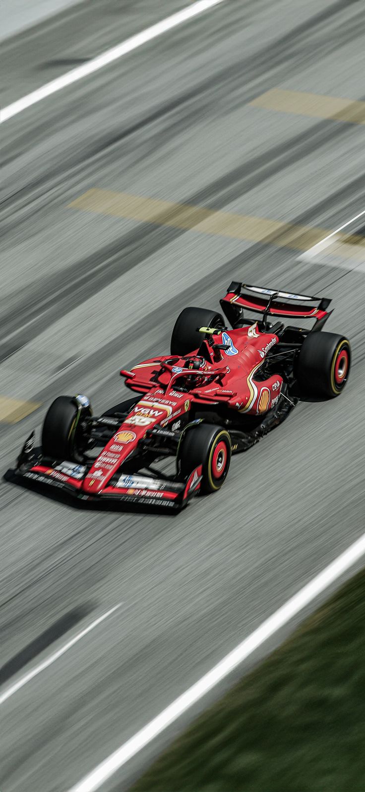 a red race car driving down the track