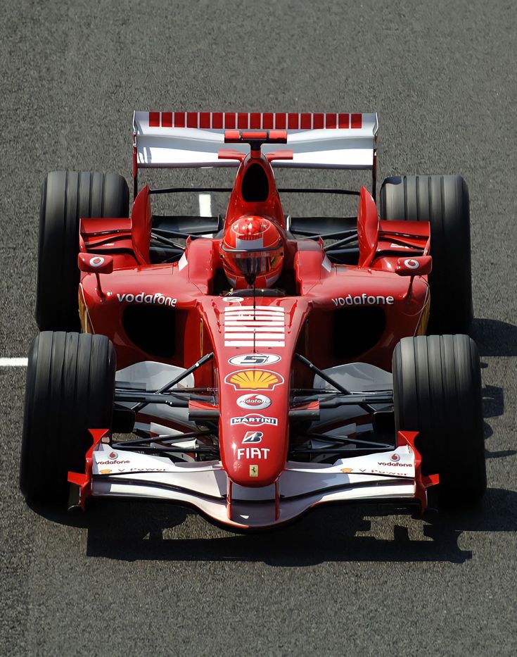 a red race car driving down the road